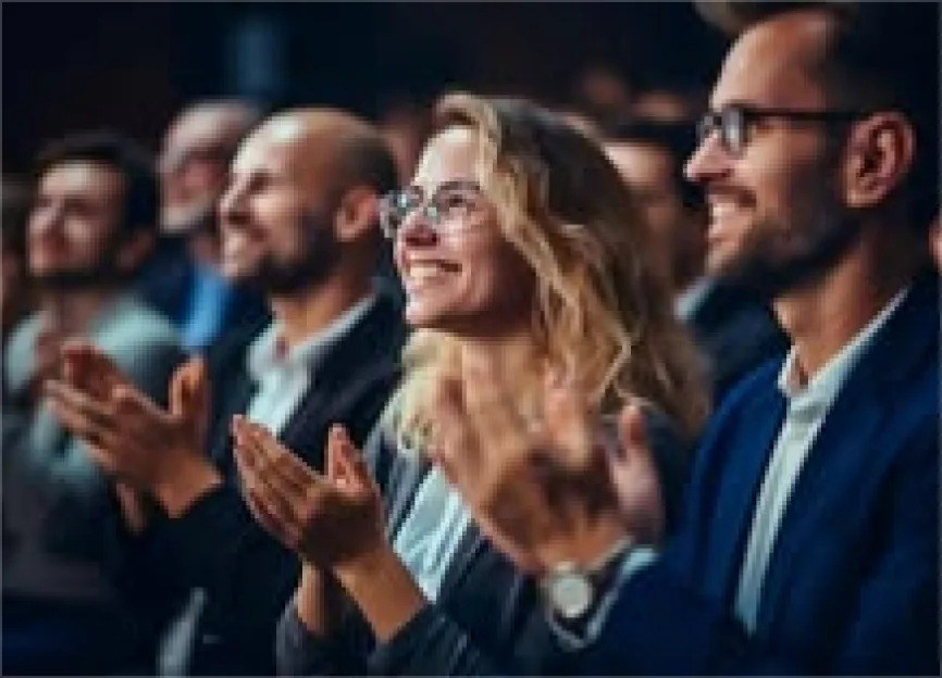 An audience applauding at a tech event